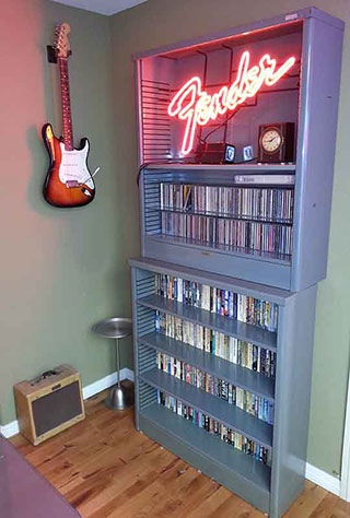 Office bookcase with guitar, fender sign