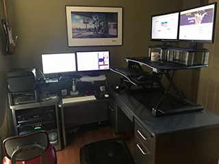 Photo of office, featuring desks and computer monitors