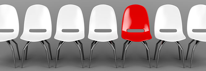 Red chair among white demonstrates uniqueness